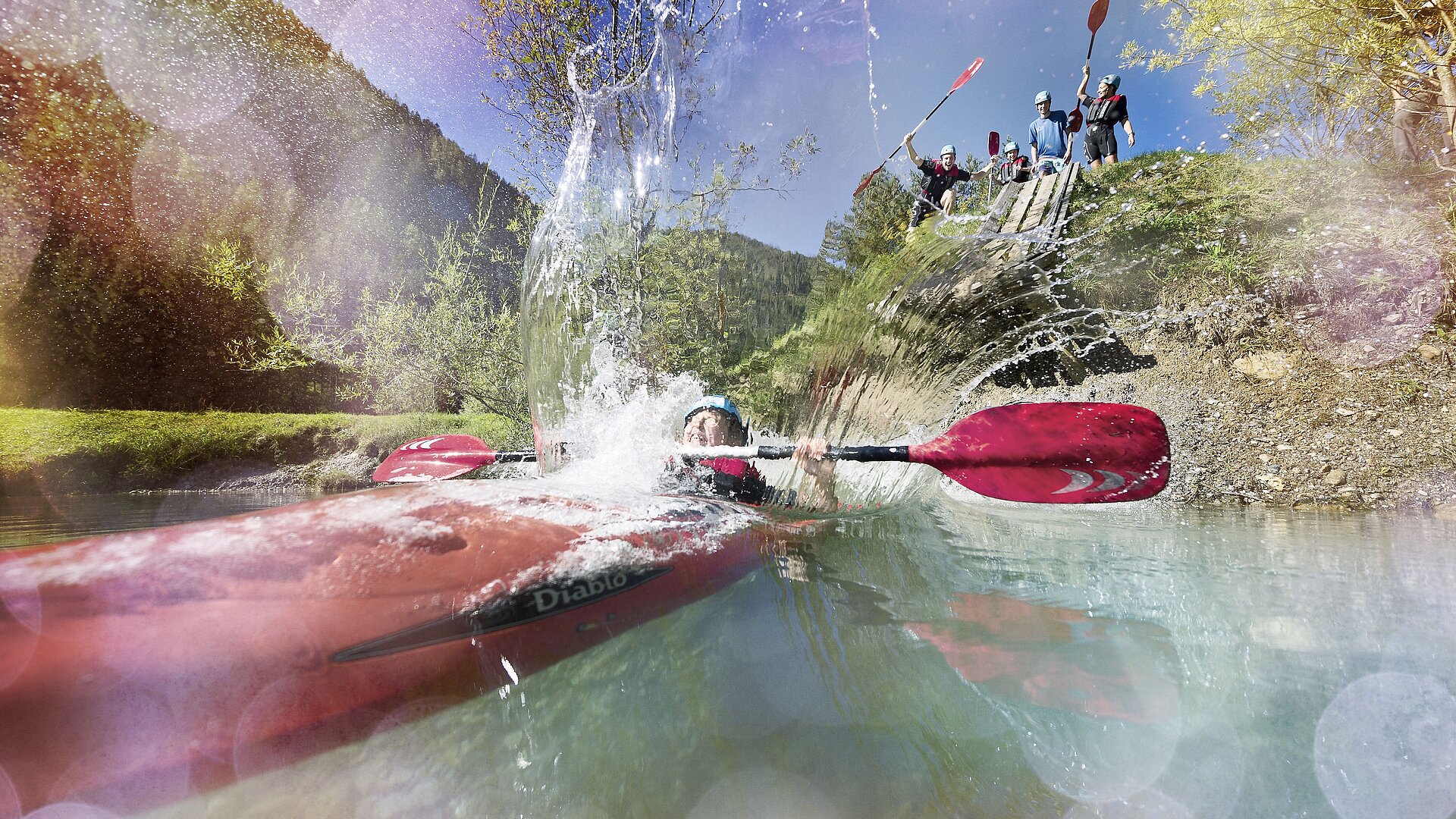 Refreshing cooling off at the kayak slide at the bathing lake in Flachauwinkl